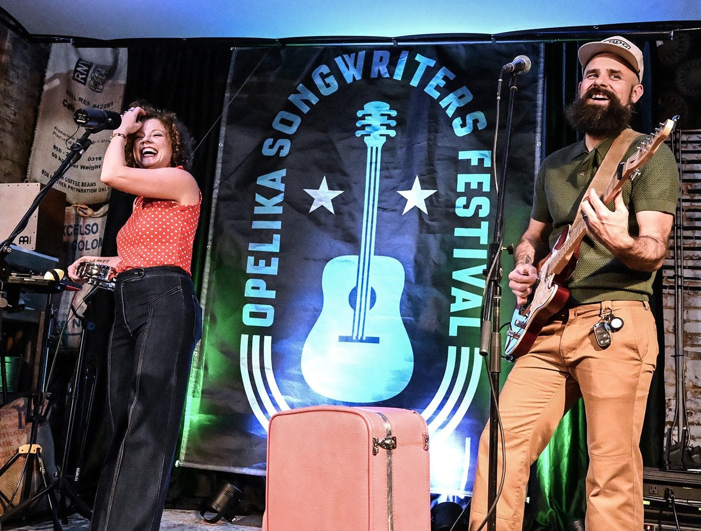Kassie Wilson and Ben Wilson of Goldpine performing in front of the festival banner