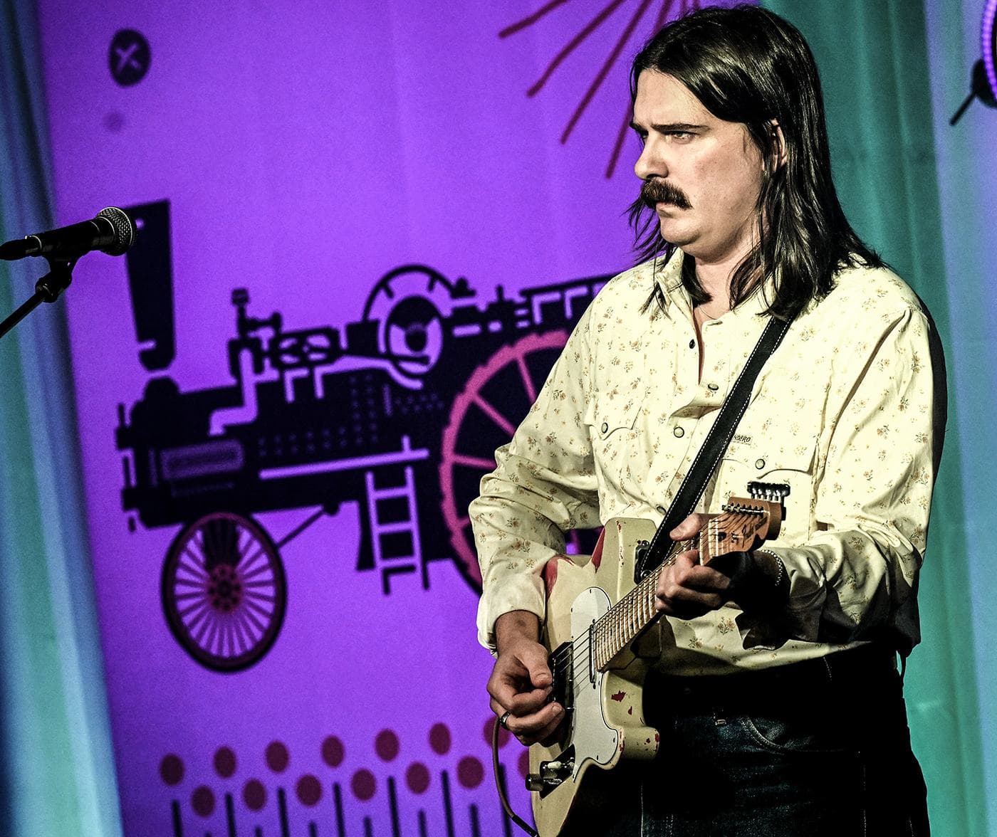 Hunter Pinkston of The Pink Stones performing under purple stage light